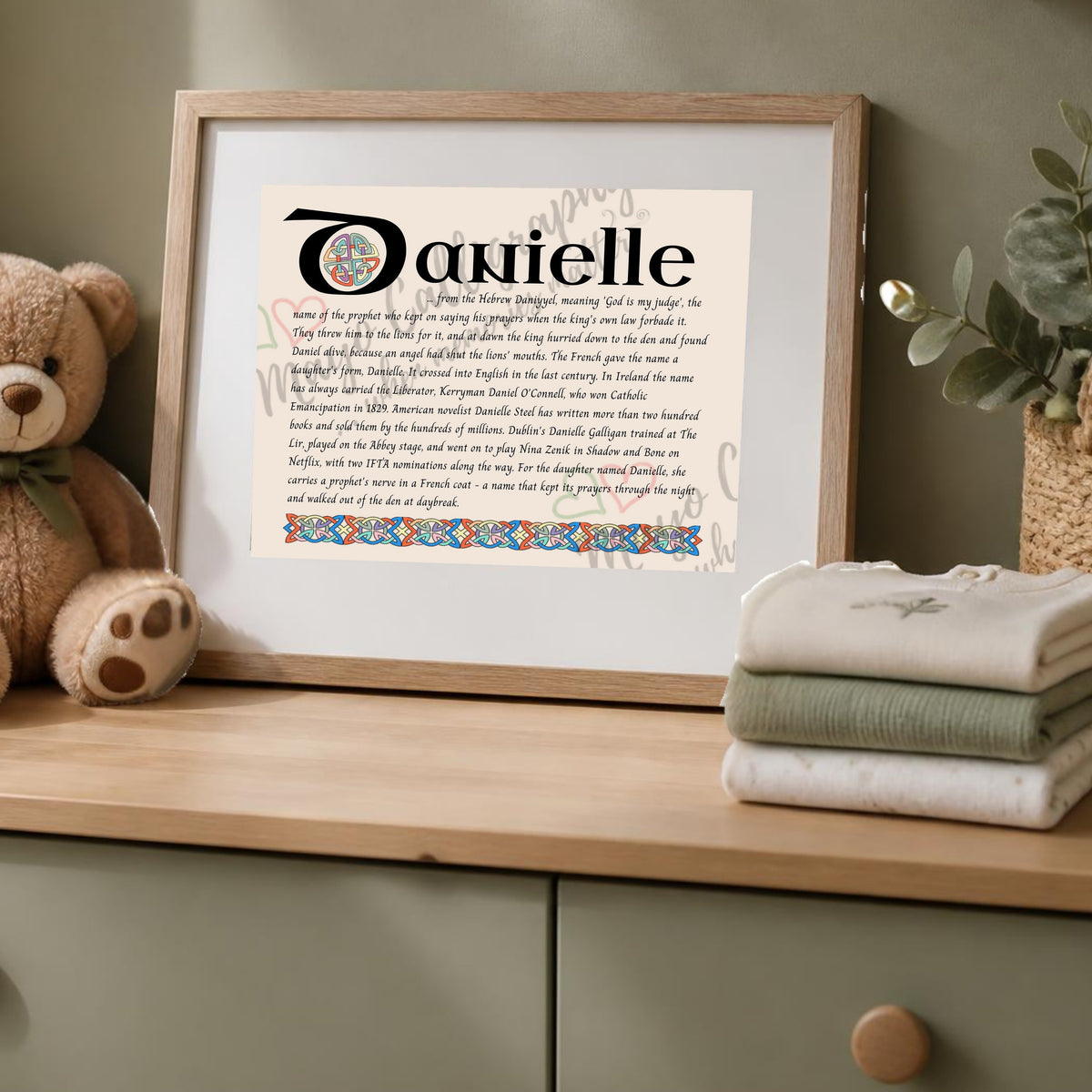 Danielle Celtic name print in a wooden frame on a dresser with a teddy bear