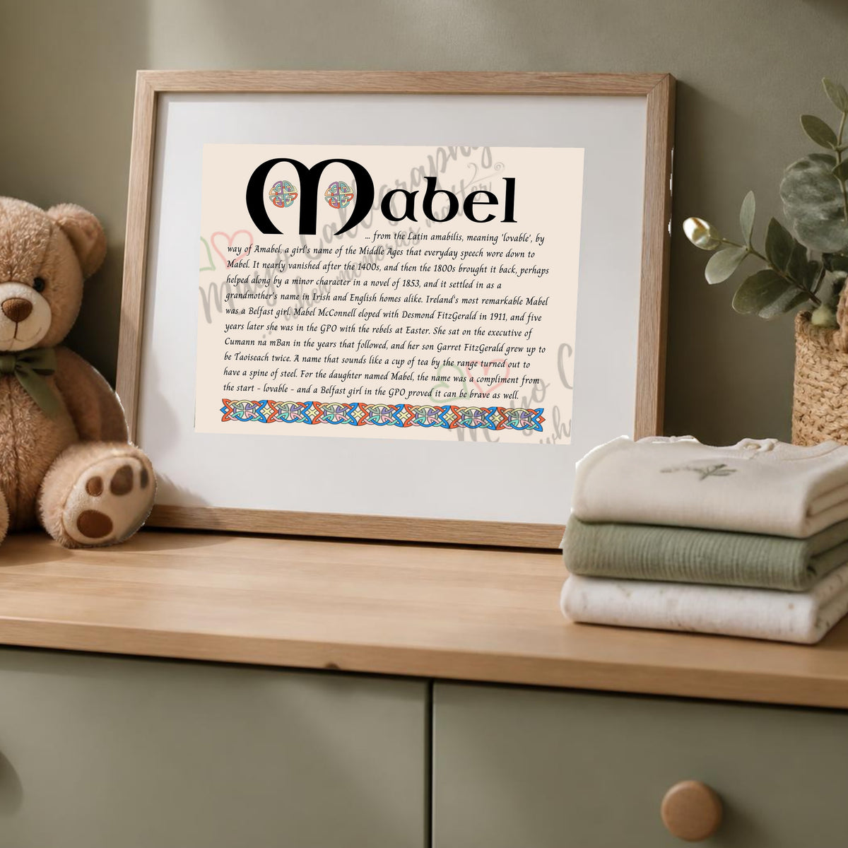 Mabel Celtic name print in a wooden frame on a dresser with a teddy bear